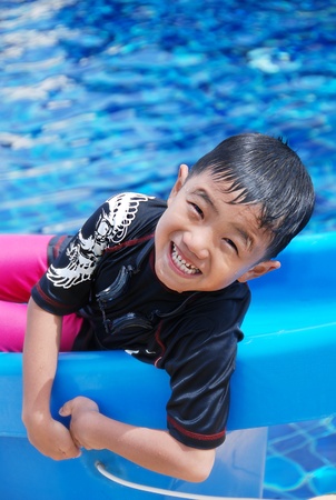portrait of a kid smiling in a swimming pool.の写真素材
