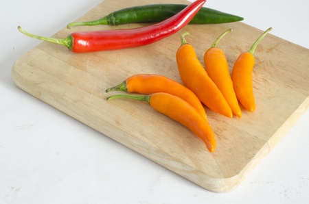 red pepper and Green Pepper on wooden boardの写真素材