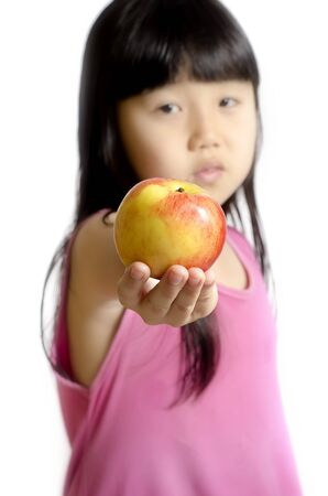 Beautiful little girl with apple soft fous isoleted on whiteの写真素材