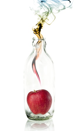 apple in Glass bottle with concept smokeの写真素材