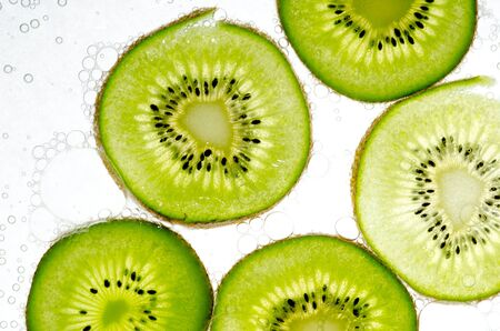 Slice kiwi fruit on white backgroundの写真素材