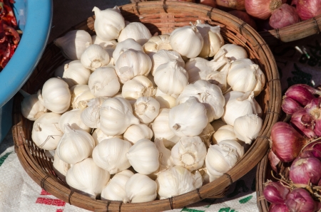 Garlic in a bamboo basket の写真素材
