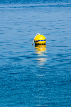 Yellow Buoy at seaの写真素材