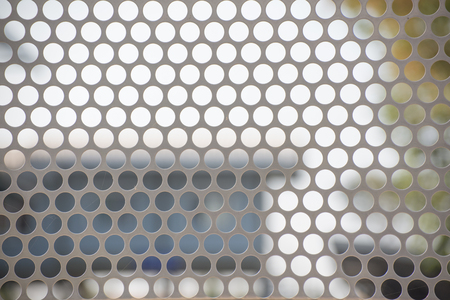Background metal with lines of circular holesの写真素材