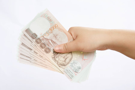 hand hold few thousand banknotes of Thailandの写真素材