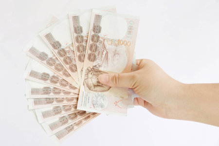 hand hold few thousand banknotes of Thailandの写真素材