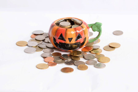 coins in the Halloween glass in white background, savingの写真素材