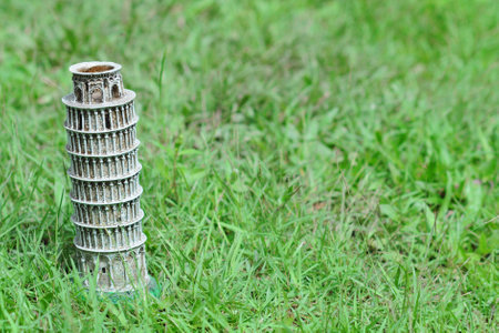 Decorative learning tower of Pisa figure on grassesの写真素材
