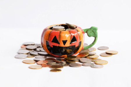 coins in the Halloween glass in white background, savingの写真素材