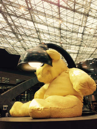 Doha, Qatar - yellow bear sitting in Qatar international airport.の素材