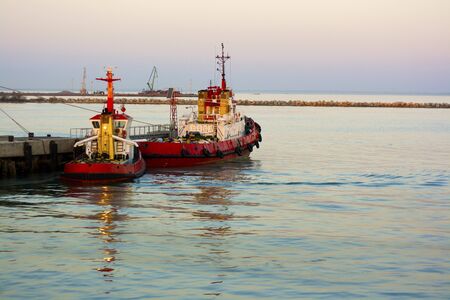two tugboats near the pierの写真素材
