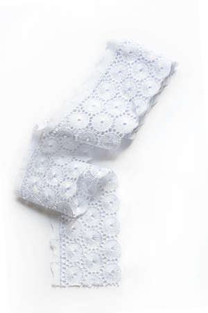 hank of white collon lace on white backgroundの写真素材