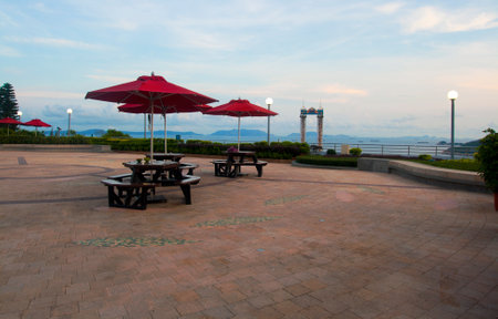 Rest zone with red umbrella and benches with a view on the sea in Ocean Park, Hong Kongのeditorial素材