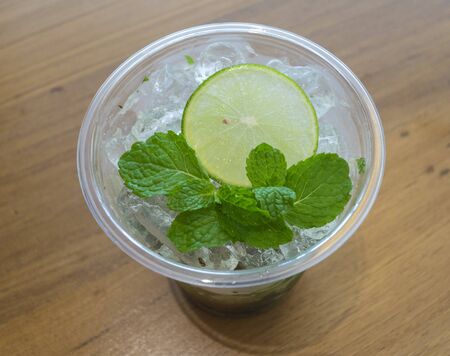 Sliced lemon and mint on ice focus on lemon
