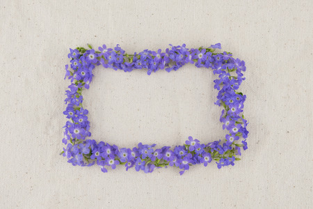Rectangle purple flowers wreath of Duranta erecta L. on muslin fabric from top view with copy spaceの写真素材