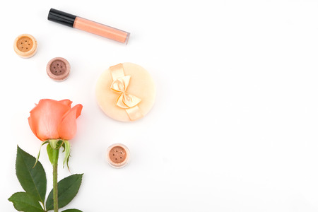 Orange roses and cosmetics with copy space on white backgroundの写真素材