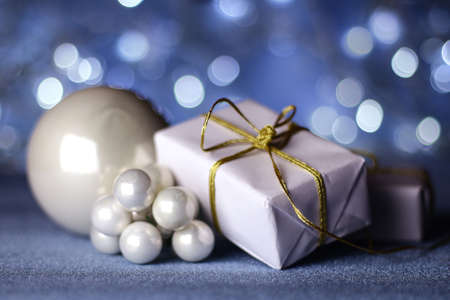 Christmas decoration. Christmas gift box and christmas tree toys with lights on background.の写真素材