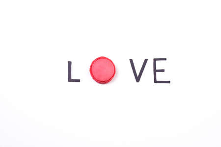 Love creative background. Hand lettering word love and sweet macaroon on white background.  Sweet...