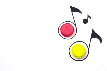 Sweet music creative background. Macaroon and hand drawn music notes  on white backgroundの写真素材