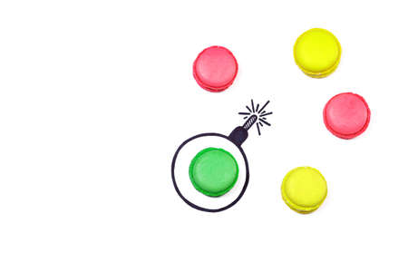 Sweet bomb. Different color macaroons and hand drawn bomb on white background. Explosion creative concept.の写真素材