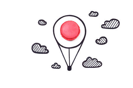Macaroon and hand drawn air balloon and clouds on white background. Travel concept.の写真素材