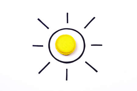 Sun. Sun illustration creative concept. Sweet macaroon sun. Hand drawing sun with yellow macaroon on white background.  Summer concept.の写真素材