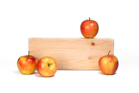 Apples and wooden signboard isolated on white backgroundの写真素材