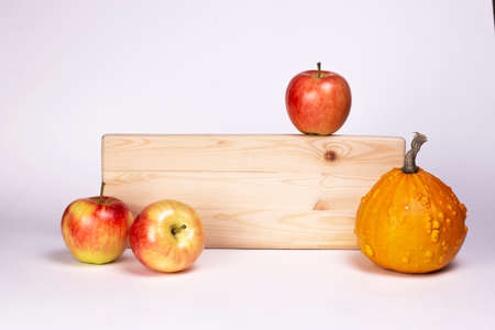 Apples and pumpkin with wooden signboard isolated on white background.の写真素材