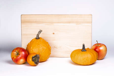 Apples and pumpkin with wooden signboard isolated on white background.の写真素材