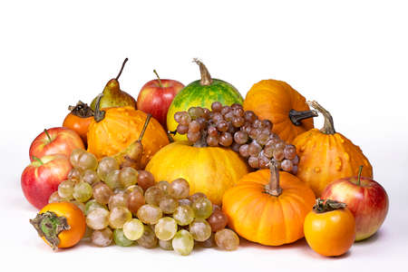 Autumn harvest isolated on white background. Pumpkins, apples, grape bunch, peers and kinglet.の写真素材