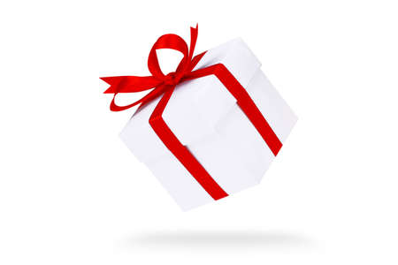 Flying white gift boxes on red background. Holiday gift concept. Part of set.の写真素材