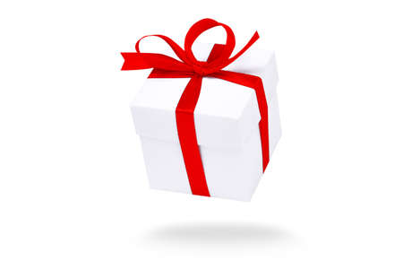 Flying white gift boxes on red background. Holiday gift concept. Part of set.の写真素材