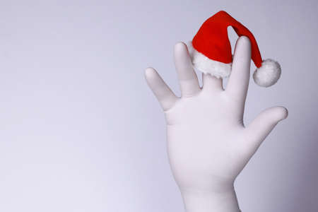 White hand show middle finger on with Santaâs hat.  Christmas and New Year and holiday concept.の写真素材
