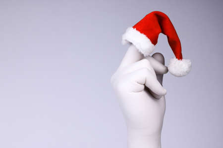 White hand show middle finger on with Santaâs hat.  Christmas and New Year and holiday conceptの写真素材