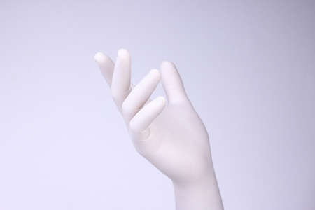 White hand. Hand with white glove on light background.の写真素材