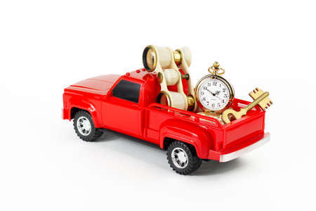 Retro opera glasses and film in red trendy pickup trunk. Toy truck, film roll and retro binoculars. Part of setの写真素材
