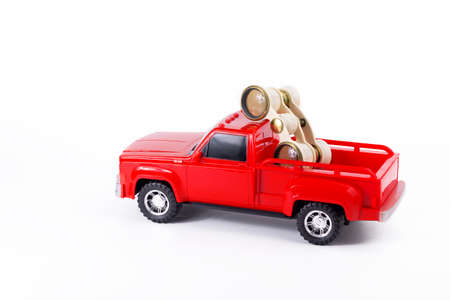 Red trendy pickup and opera glasses in the trunk. Toy truck and retro binoculars. Part of set.の写真素材