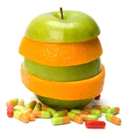 mixed sliced fruits and pills isolated on white backgroundの写真素材