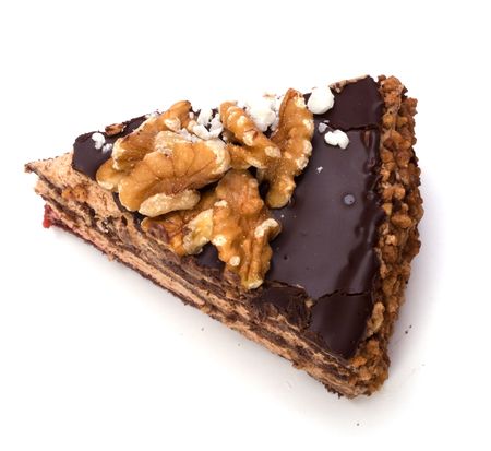 Slice of chocolate cream cake isolated on whiteの写真素材