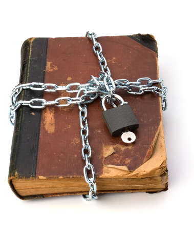 tattered book with chain and padlock isolated on white backgroundの写真素材