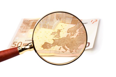hand magnifier over banknote isolated on white backgroundの写真素材