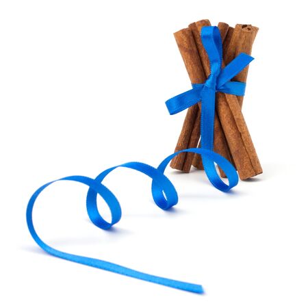 Festive wrapped cinnamon sticks isolated on white backgroundの写真素材
