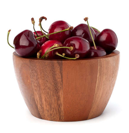 Cherry in wooden bowl isolated on white backgroundの写真素材