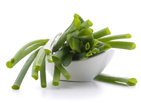 Spring onions in bowl isolated on white background cutoutの写真素材