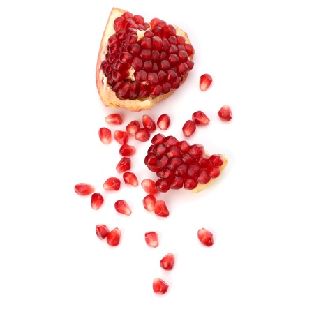 Ripe pomegranate piece  isolated on white backgroundの写真素材