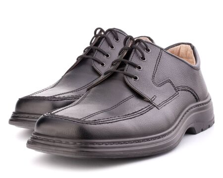 Black glossy manâs shoes with shoelaces isolated on white backgroundの写真素材