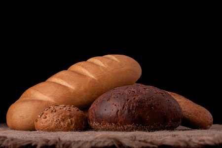 Assortment of breads still life on rustic backgroundの写真素材