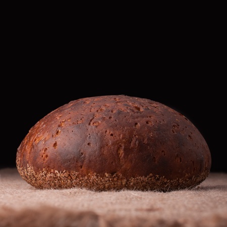 Loaf of rye bread on rustic backgroundの写真素材