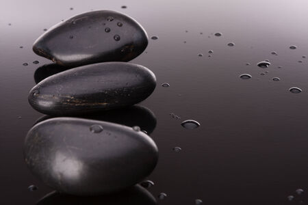 Spa stone arrangement on black surface. Healthcare concept.の写真素材