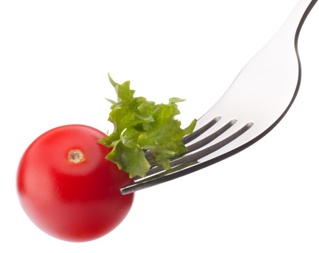 Fresh salad and cherry tomato on fork isolated on white backgroundの写真素材